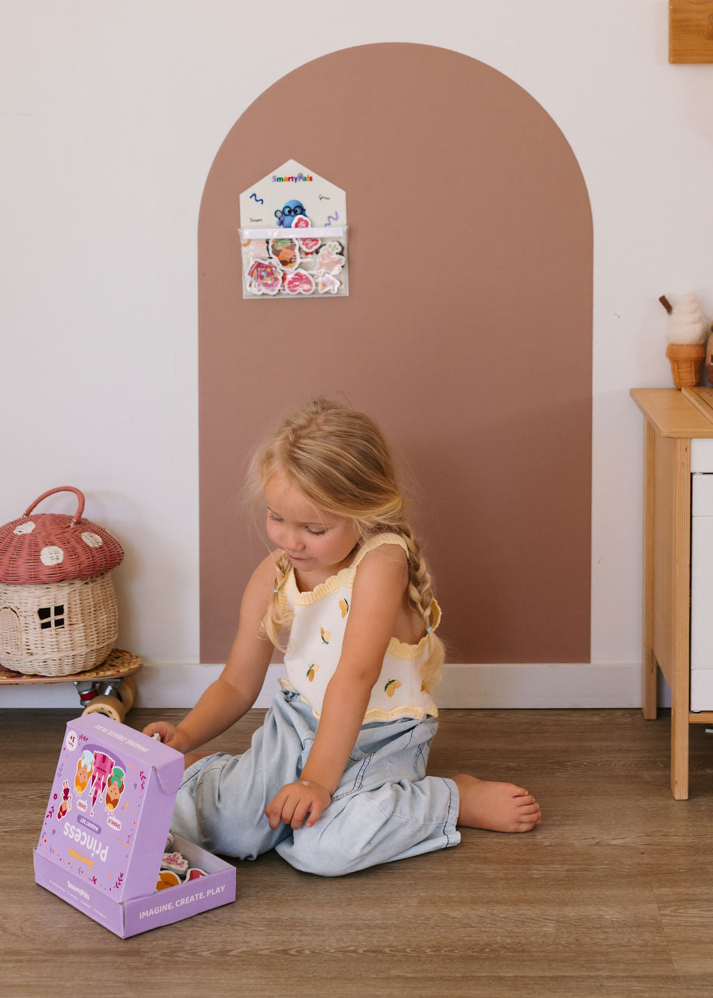 Child playing independently with magnetic toys on a play wall