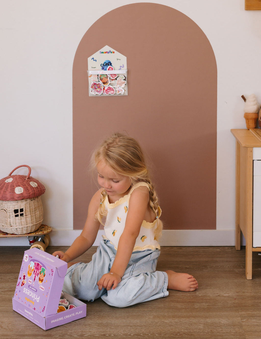 Child playing independently with magnetic toys on a Smartypals play wall